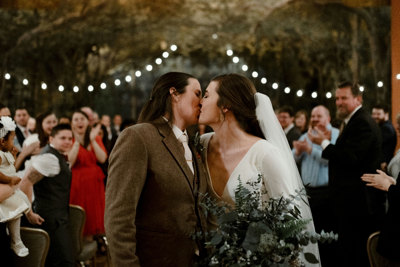 couple kissing on wedding day in ceremony